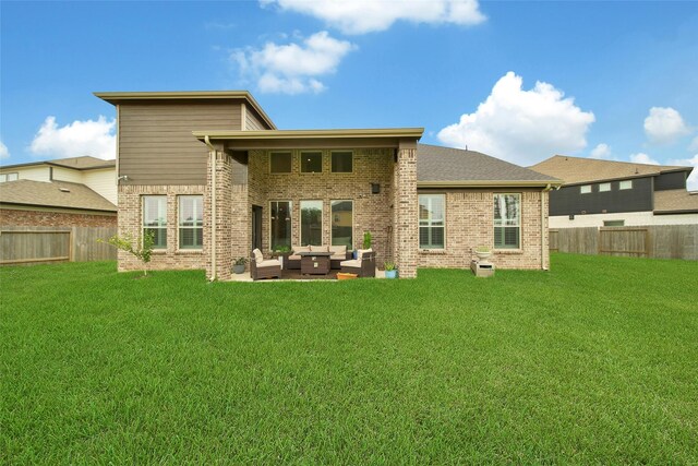 3140 Red Buckeye Ln, Conroe, TX 77301 - back of property with outdoor lounge area, brick siding, a fenced backyard, and a patio
