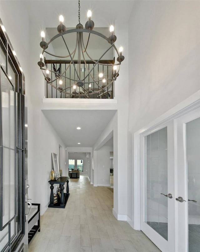 3140 Red Buckeye Ln, Conroe, TX 77301 - foyer entrance featuring a high ceiling, french doors, and a chandelier