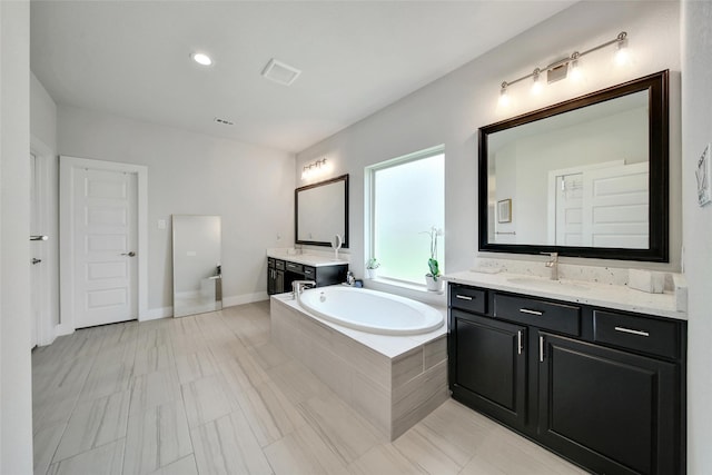3140 Red Buckeye Ln, Conroe, TX 77301 - bathroom with two vanities and a garden tub