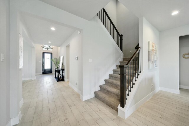 3140 Red Buckeye Ln, Conroe, TX 77301 - entryway with light wood-style flooring, stairway, recessed lighting, and a chandelier