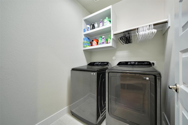 3140 Red Buckeye Ln, Conroe, TX 77301 - laundry room featuring washing machine and clothes dryer and baseboards