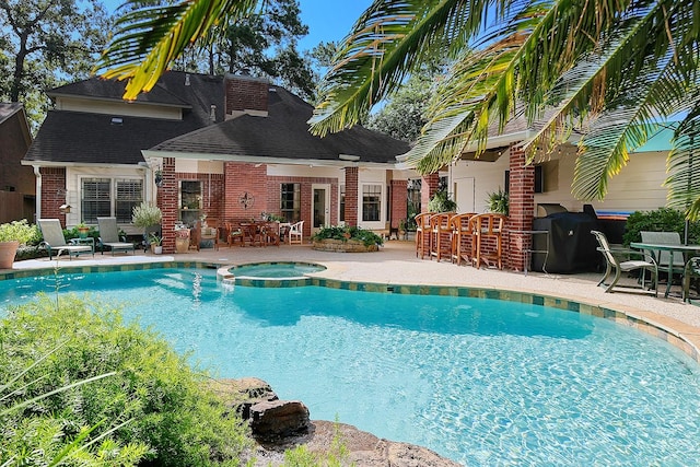 15 Amber Sky Pl, The Woodlands, TX 77381 - view of swimming pool with a patio area, area for grilling, a pool with connected hot tub, and outdoor dining area