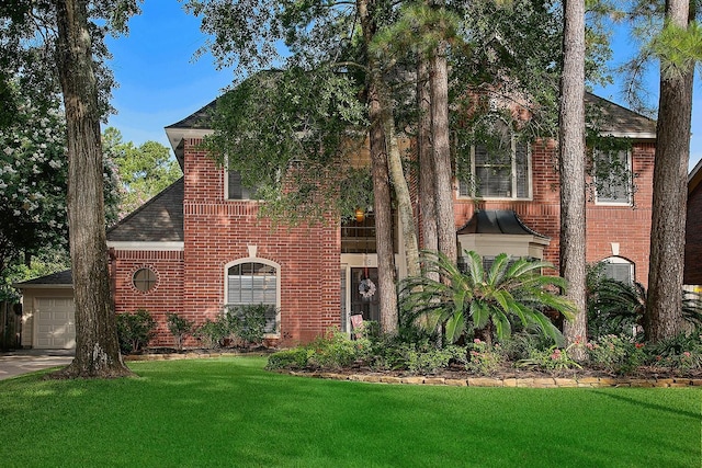 15 Amber Sky Pl, The Woodlands, TX 77381 - view of front of house featuring brick siding, a front lawn, a garage, and a shingled roof