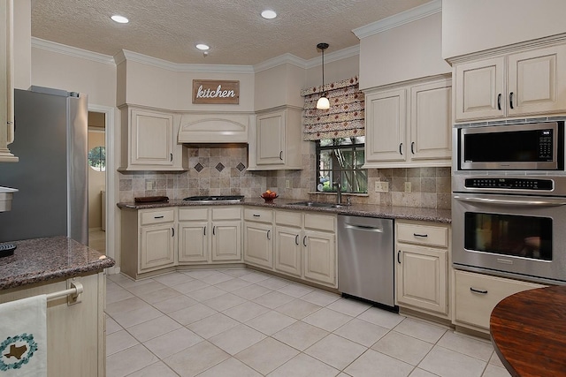 15 Amber Sky Pl, The Woodlands, TX 77381 - kitchen with stainless steel appliances, light tile patterned flooring, decorative backsplash, a textured ceiling, and dark stone countertops