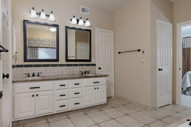 15 Amber Sky Pl, The Woodlands, TX 77381 - bathroom with double vanity, backsplash, connected bathroom, and tile patterned floors