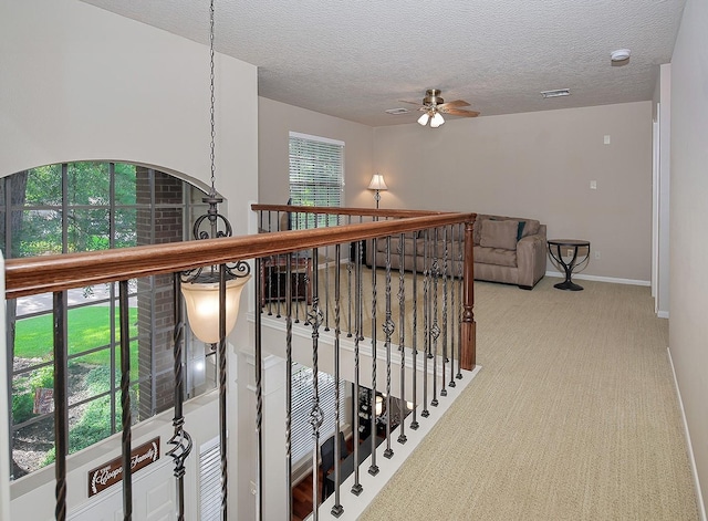 15 Amber Sky Pl, The Woodlands, TX 77381 - hall with carpet floors and a textured ceiling