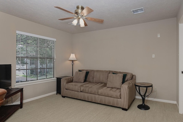 15 Amber Sky Pl, The Woodlands, TX 77381 - living area with a ceiling fan, light colored carpet, and a textured ceiling