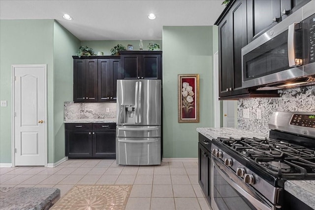 10002 Dawn Brook Dr, Pearland, TX 77584 - kitchen with stainless steel appliances, decorative backsplash, light tile patterned flooring, light stone countertops, and recessed lighting