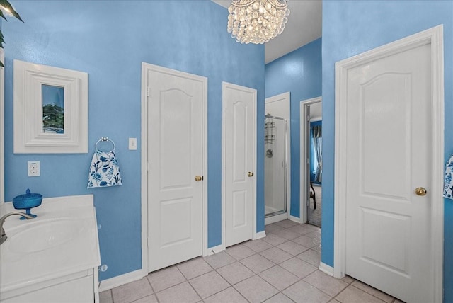 10002 Dawn Brook Dr, Pearland, TX 77584 - bathroom featuring tile patterned floors, a shower stall, a chandelier, vanity, and a high ceiling