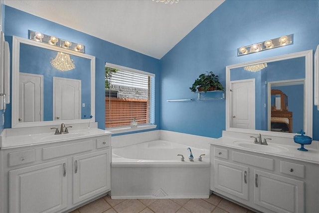 10002 Dawn Brook Dr, Pearland, TX 77584 - ensuite bathroom with lofted ceiling, two vanities, a garden tub, and tile patterned floors