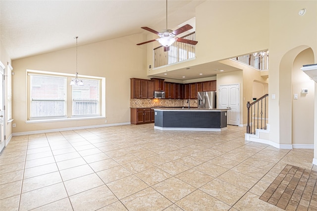 22411 Limestone Crest Ln, Katy, TX 77449 - kitchen featuring stainless steel appliances, light tile patterned flooring, decorative backsplash, ceiling fan, and arched walkways