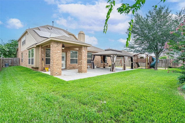22411 Limestone Crest Ln, Katy, TX 77449 - back of property with a patio area, a gazebo, brick siding, ceiling fan, and solar panels
