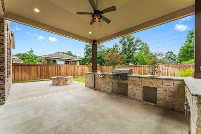 4038 Sabine Valley Trl, Spring, TX 77386 - fenced backyard with an outdoor kitchen, a fire pit, a patio, and ceiling fan