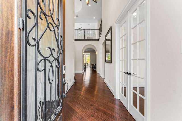 4038 Sabine Valley Trl, Spring, TX 77386 - foyer entrance featuring arched walkways, french doors, dark wood finished floors, and a towering ceiling