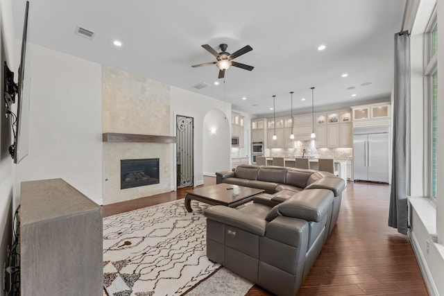 4038 Sabine Valley Trl, Spring, TX 77386 - living room with a ceiling fan, dark wood-style floors, a large fireplace, and recessed lighting