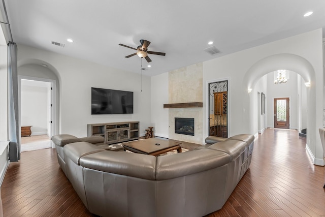 4038 Sabine Valley Trl, Spring, TX 77386 - living area with arched walkways, a fireplace, ceiling fan, dark wood finished floors, and recessed lighting