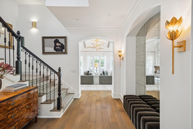 10825 Smithdale Rd, Houston, TX 77024 - foyer entrance featuring arched walkways, wood-type flooring, stairs, and ornamental molding