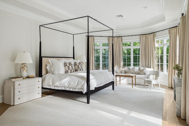 10825 Smithdale Rd, Houston, TX 77024 - bedroom with multiple windows, crown molding, and a tray ceiling