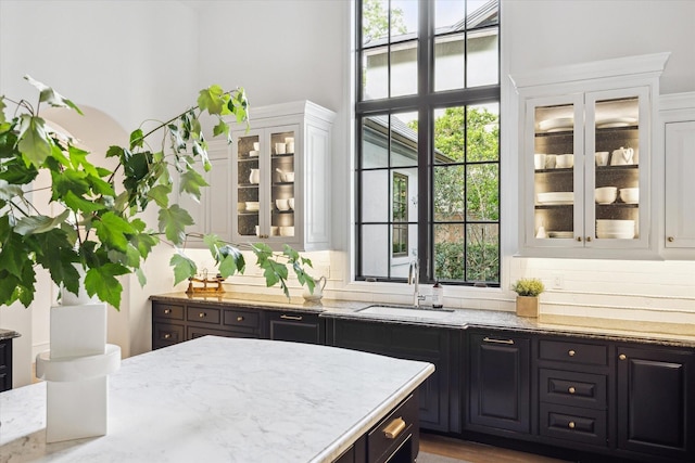 10825 Smithdale Rd, Houston, TX 77024 - kitchen with white cabinets, healthy amount of natural light, and light stone countertops