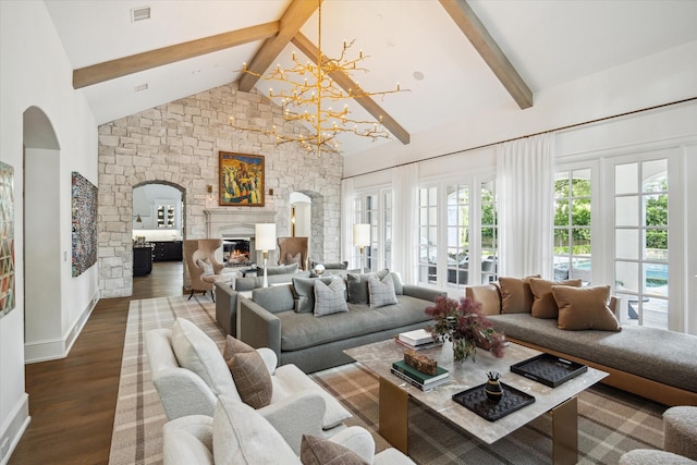 10825 Smithdale Rd, Houston, TX 77024 - living area with arched walkways, wood finished floors, a chandelier, and a glass covered fireplace