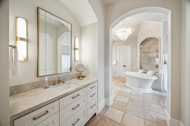 10825 Smithdale Rd, Houston, TX 77024 - bathroom with vanity, a soaking tub, tiled shower, and stone finish floors
