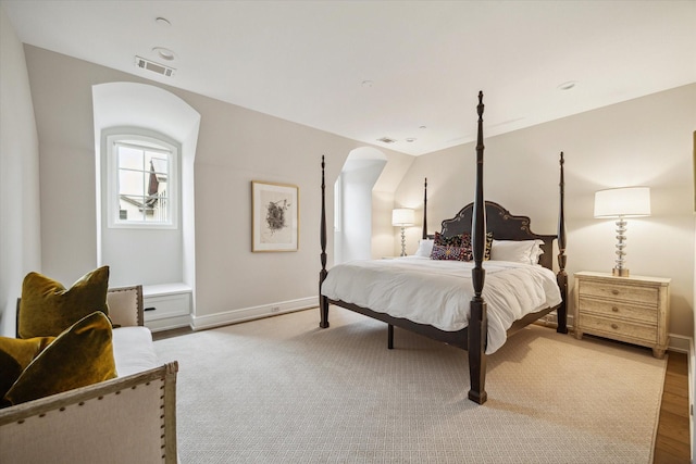 10825 Smithdale Rd, Houston, TX 77024 - bedroom featuring arched walkways and wood finished floors