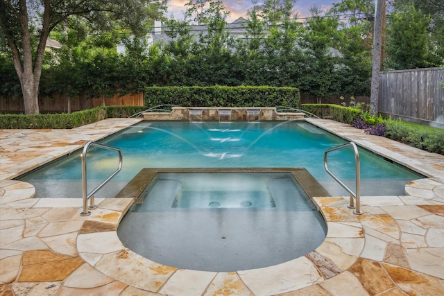 10825 Smithdale Rd, Houston, TX 77024 - pool at dusk featuring a fenced backyard, a pool with connected hot tub, and a patio area