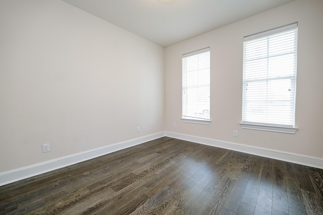 8682 Green Kolbe Ln, Houston, TX 77080 - spare room featuring baseboards and dark wood-style floors