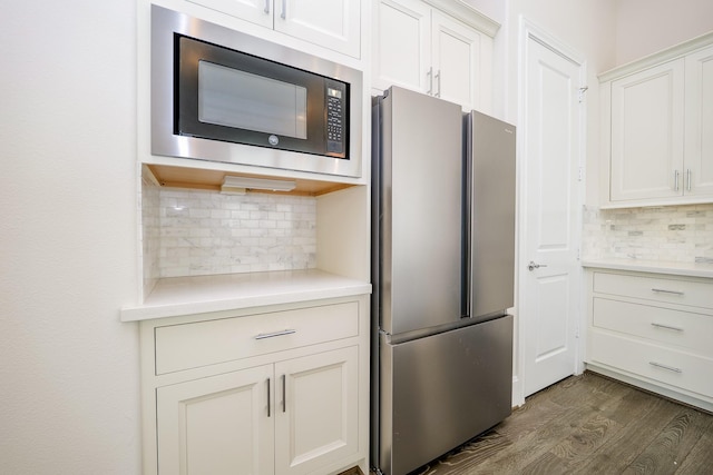 8682 Green Kolbe Ln, Houston, TX 77080 - kitchen featuring freestanding refrigerator, black microwave, backsplash, and light countertops
