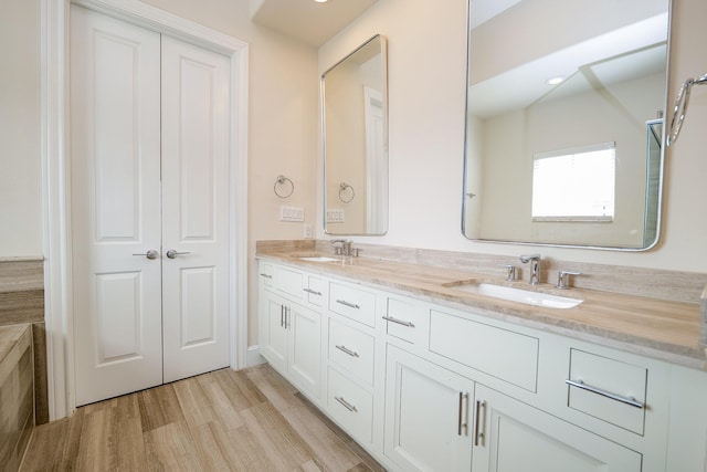 8682 Green Kolbe Ln, Houston, TX 77080 - full bathroom with double vanity and wood finished floors