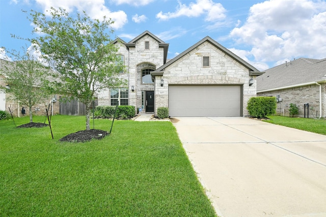4437 Jessamine Creek Trl, Rosharon, TX 77583 - french country style house with a garage, concrete driveway, a front yard, and stone siding