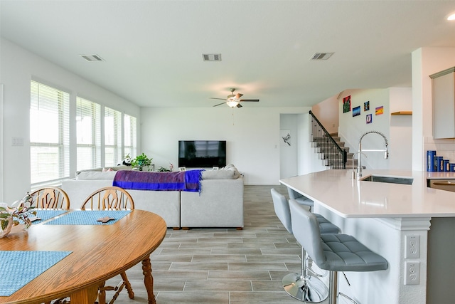 4437 Jessamine Creek Trl, Rosharon, TX 77583 - living room with ceiling fan, stairway, and light wood finished floors