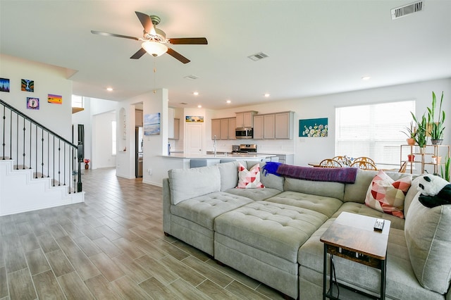 4437 Jessamine Creek Trl, Rosharon, TX 77583 - living area featuring ceiling fan, stairway, light wood-style flooring, and recessed lighting