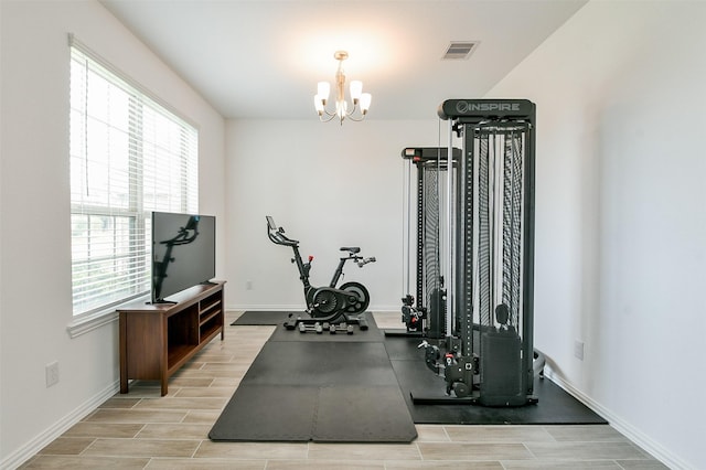 4437 Jessamine Creek Trl, Rosharon, TX 77583 - workout room with healthy amount of natural light, a chandelier, and wood finish floors