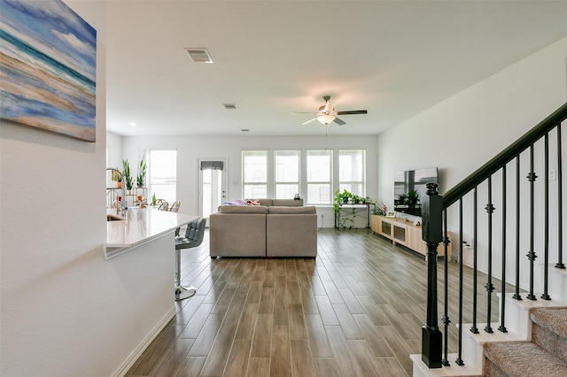 4437 Jessamine Creek Trl, Rosharon, TX 77583 - living area with a ceiling fan, stairs, and dark wood finished floors