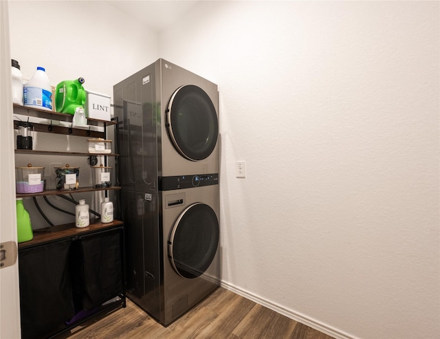 21427 Hawthorn Prairie Dr, New Caney, TX 77357 - washroom with stacked washing machine and dryer and wood finished floors