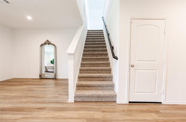 21427 Hawthorn Prairie Dr, New Caney, TX 77357 - stairway with wood finished floors and recessed lighting