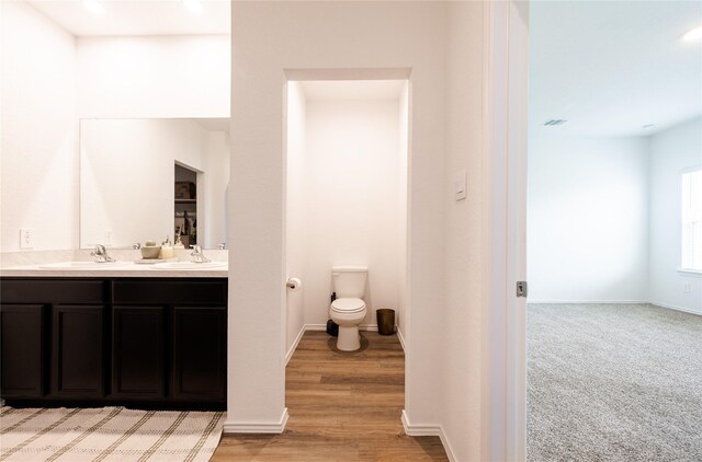 21427 Hawthorn Prairie Dr, New Caney, TX 77357 - full bathroom with double vanity, wood finished floors, and recessed lighting