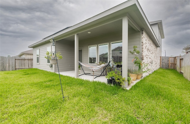 21427 Hawthorn Prairie Dr, New Caney, TX 77357 - rear view of house with a fenced backyard and a patio area