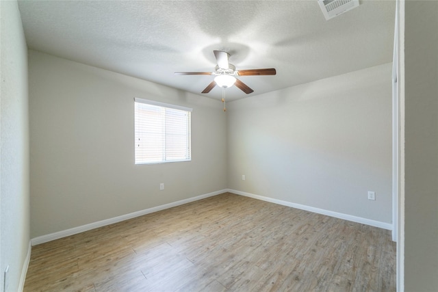 10126 Relic Oaks, San Antonio, TX 78240 - unfurnished room with a ceiling fan, light wood finished floors, and a textured ceiling