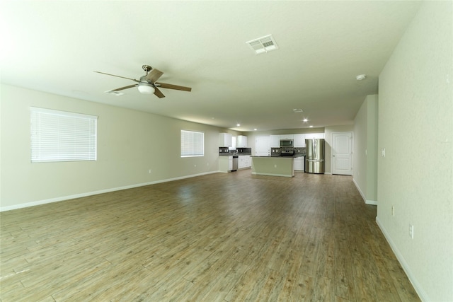 10126 Relic Oaks, San Antonio, TX 78240 - unfurnished living room featuring a ceiling fan and wood finished floors