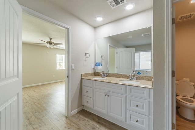 10126 Relic Oaks, San Antonio, TX 78240 - bathroom featuring double vanity, wood finished floors, and healthy amount of natural light