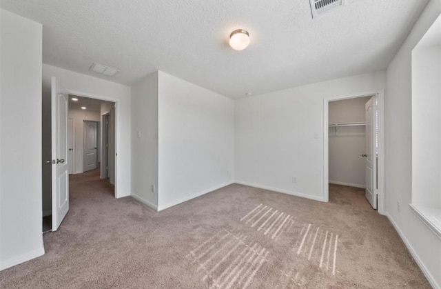 2019 Damasi Ln, Fresno, TX 77545 - unfurnished bedroom with carpet, a spacious closet, a textured ceiling, and a closet