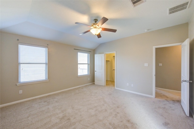 8115 Heartbrook Field Ln, Cypress, TX 77433 - unfurnished bedroom featuring lofted ceiling, light colored carpet, a spacious closet, and a ceiling fan