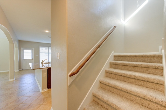 8115 Heartbrook Field Ln, Cypress, TX 77433 - stairway featuring arched walkways, tile patterned floors, and recessed lighting