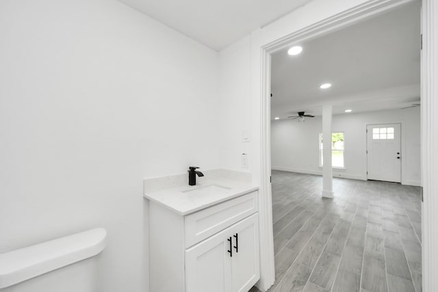 7208 Helmers St, Houston, TX 77022 - bathroom with recessed lighting, vanity, a ceiling fan, and wood finished floors