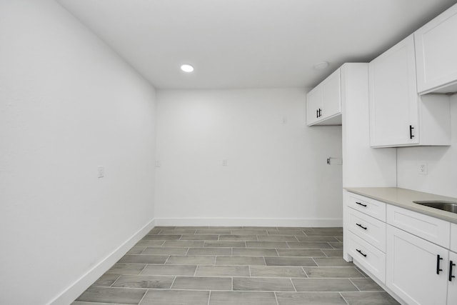 7208 Helmers St, Houston, TX 77022 - kitchen featuring white cabinetry, recessed lighting, light countertops, and light wood-style flooring