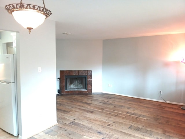 2379 Briarwest Blvd Unit 46, Houston, TX 77077 - unfurnished living room with wood finished floors and a tiled fireplace