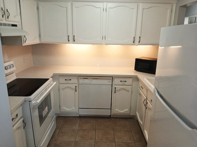 2379 Briarwest Blvd Unit 46, Houston, TX 77077 - kitchen featuring white appliances, under cabinet range hood, white cabinetry, and dark tile patterned floors