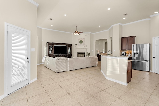 26642 Becker Pines Ln, Katy, TX 77494 - living room with arched walkways, a ceiling fan, crown molding, recessed lighting, and light tile patterned flooring